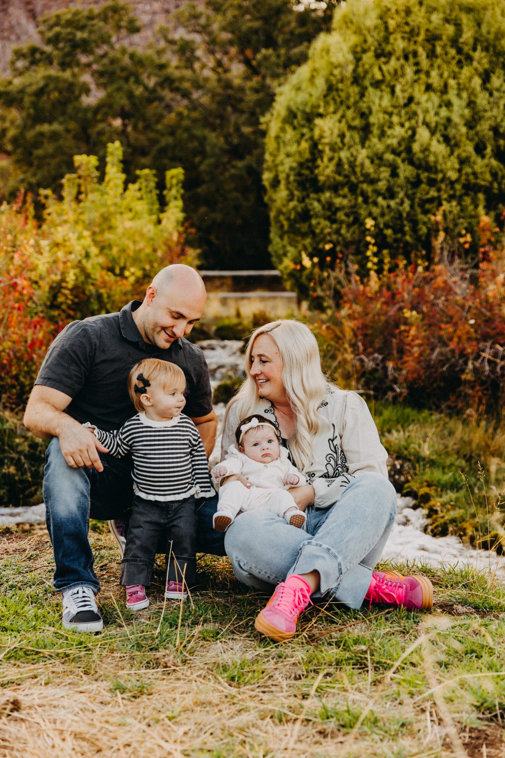 Family portrait session in Salina, Utah with parents and children smiling outdoors Central Utah family photography session during golden hour in Sevier County Family of five posing in a mountain meadow near Richfield, Utah Extended family portrait session in Sanpete County, Utah