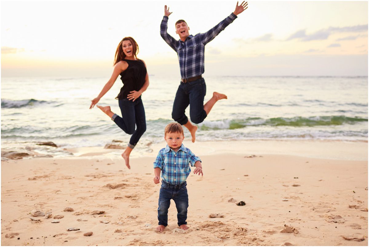 family jumping portrait on the beach