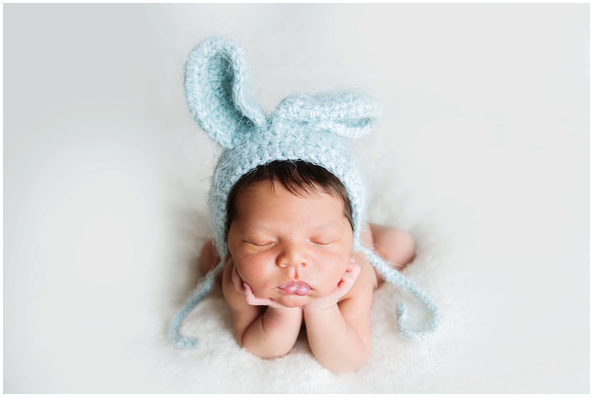 Scranton Newborn Studio Photographer head in hands pose with bunny hat