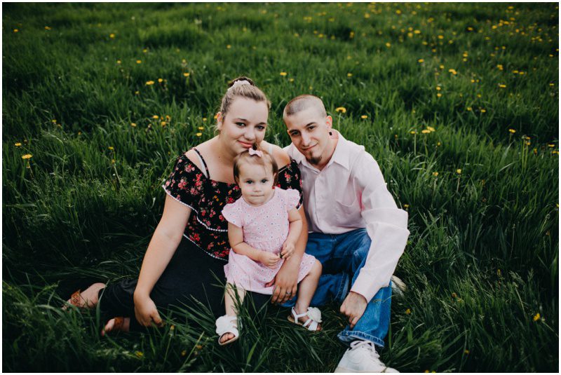 Adorable Family Portrait Session in Bloomsburg, Pennsylvania, sitting in a field of grass and flowers