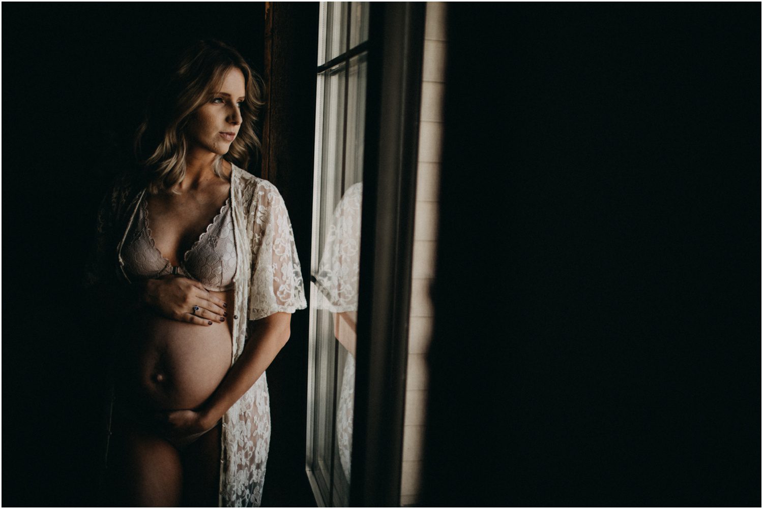 pregnant woman by a natural light window, Lifestyle Maternity Portraits in NEPA