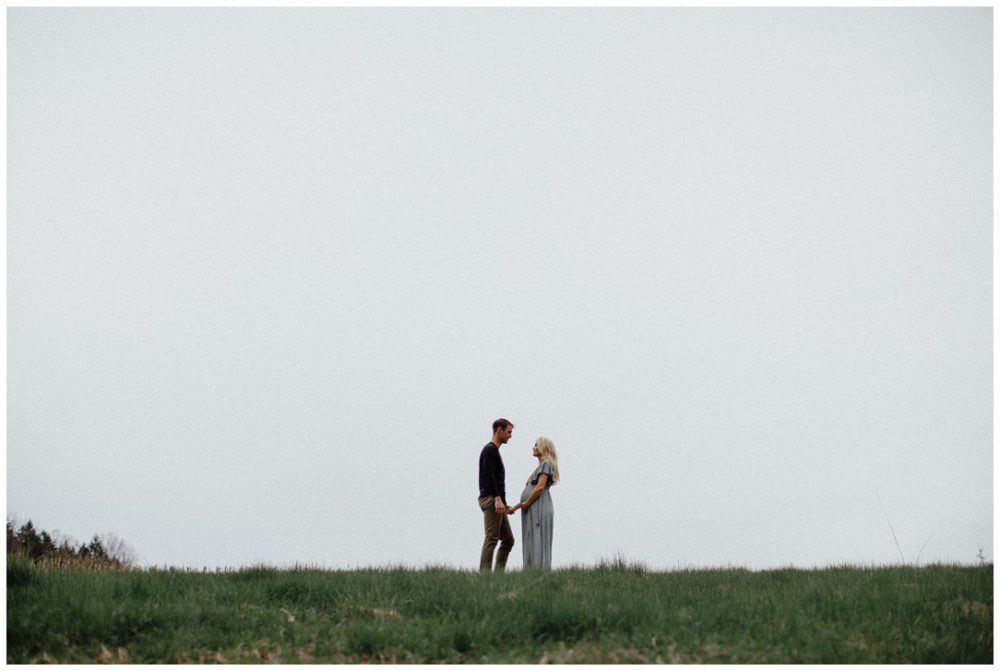 negative space, Catawissa Outdoor Maternity Photographer, expecting couple standing on a hill