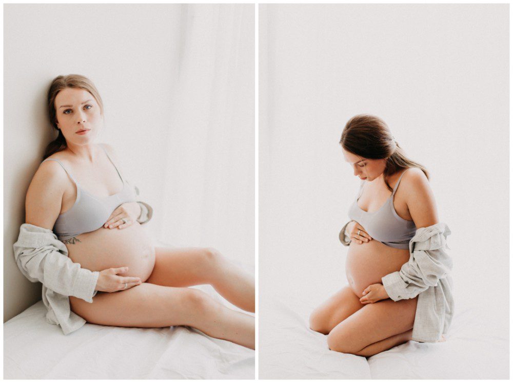 Wilkes Barre Maternity Photographer, pregnant mother sitting on bed showing belly